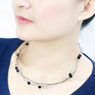 Elegant woman's ruthenium white metal necklace with black beads for a stylish look