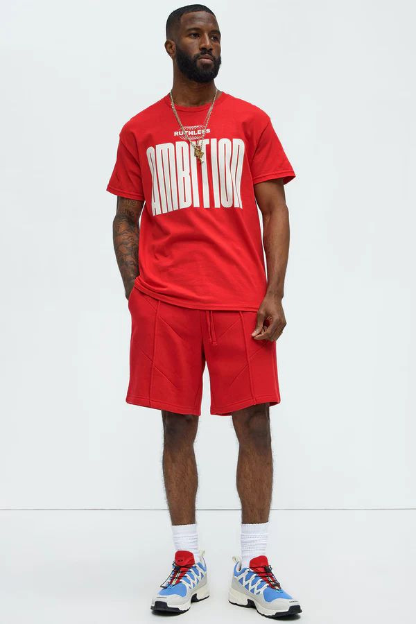 Men's ruthless ambition t-shirt for men in red with bold white text, styled with matching red shorts