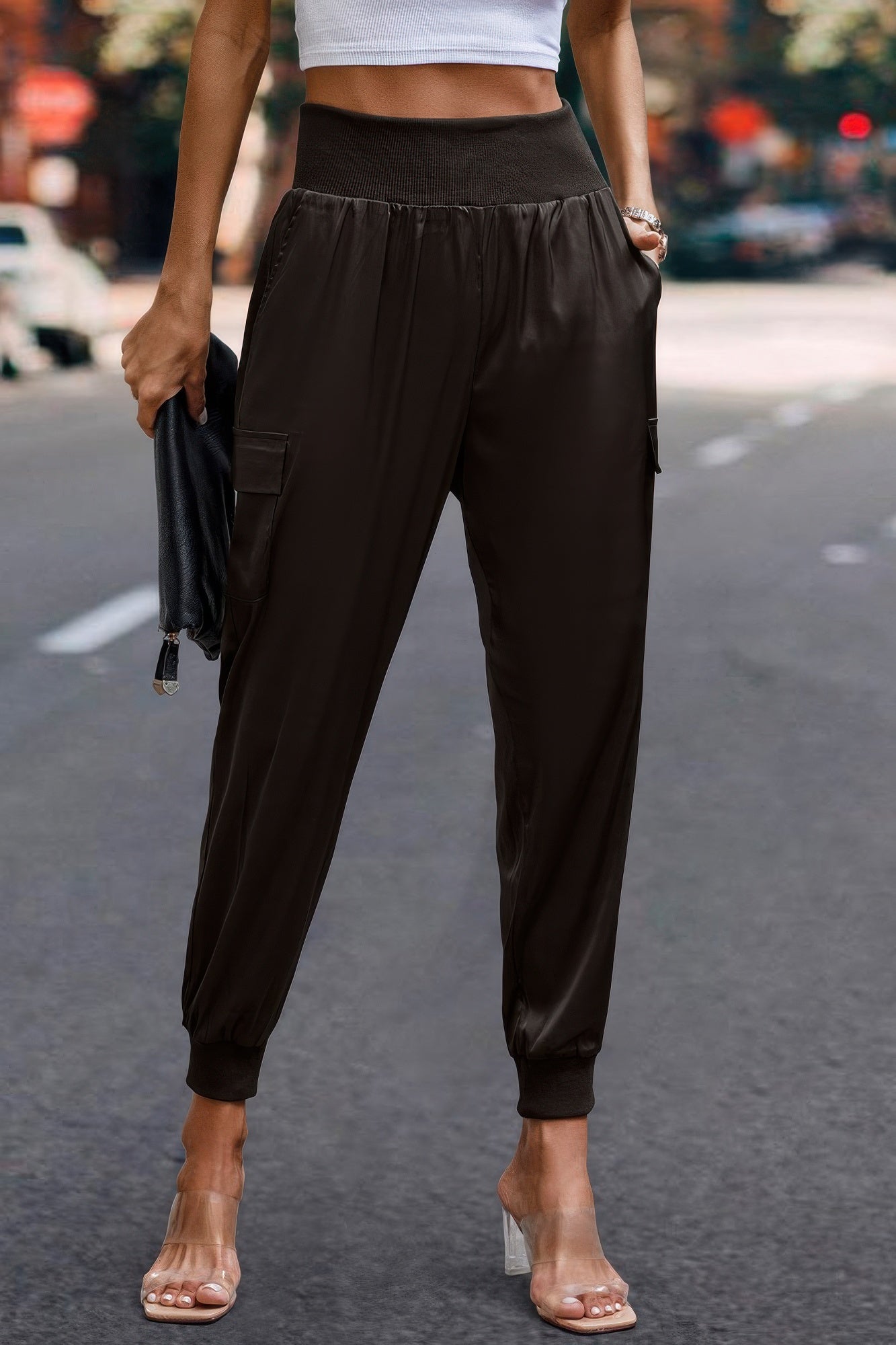 Women wearing black satin cargo joggers with elastic cuffs and high waistband by VacationGrabs
