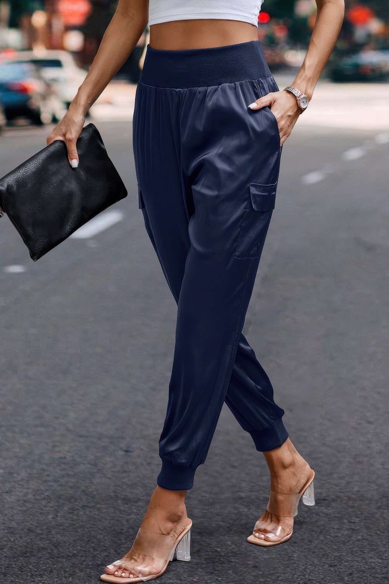 VacationGrabs navy satin cargo joggers for women styled with clear heeled sandals and black clutch