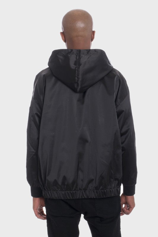 Back view of black satin hooded windbreaker jacket by WEIV worn by male model