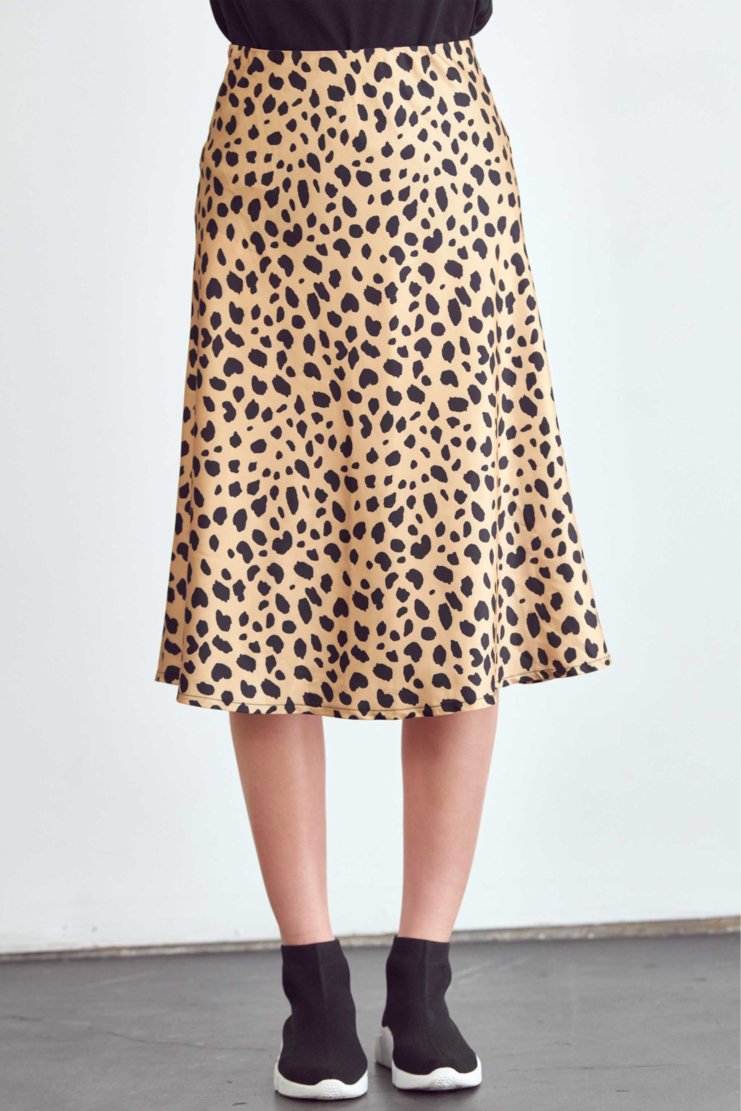 BLUME AND CO. satin midi skirt for women in leopard print worn with black top and sneakers