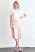 BLUME AND CO. satin midi skirt for women in soft pink styled with a white t-shirt and black sandals