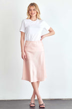 BLUME AND CO. satin midi skirt for women in soft pink styled with a white t-shirt and black sandals