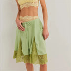 Women's green satin shorts with lace trim, perfect for lounging