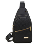 Black quilted sling bag for travel, featuring multiple pockets