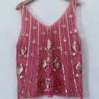 Women's pink sequin top with intricate beadwork for festive occasions