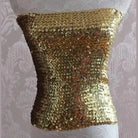 Gold sequin tube top for women displayed on a mannequin with shiny, reflective sequins
