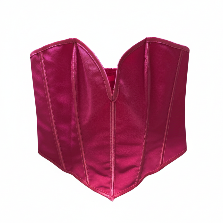 Pink corset on a hanger against a white background