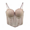 Beige corset on a hanger against a white background