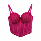 Pink corset top on a gold hanger against a white background