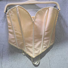 Beige sexy party club bustier top with structured seams hanging on a white hanger