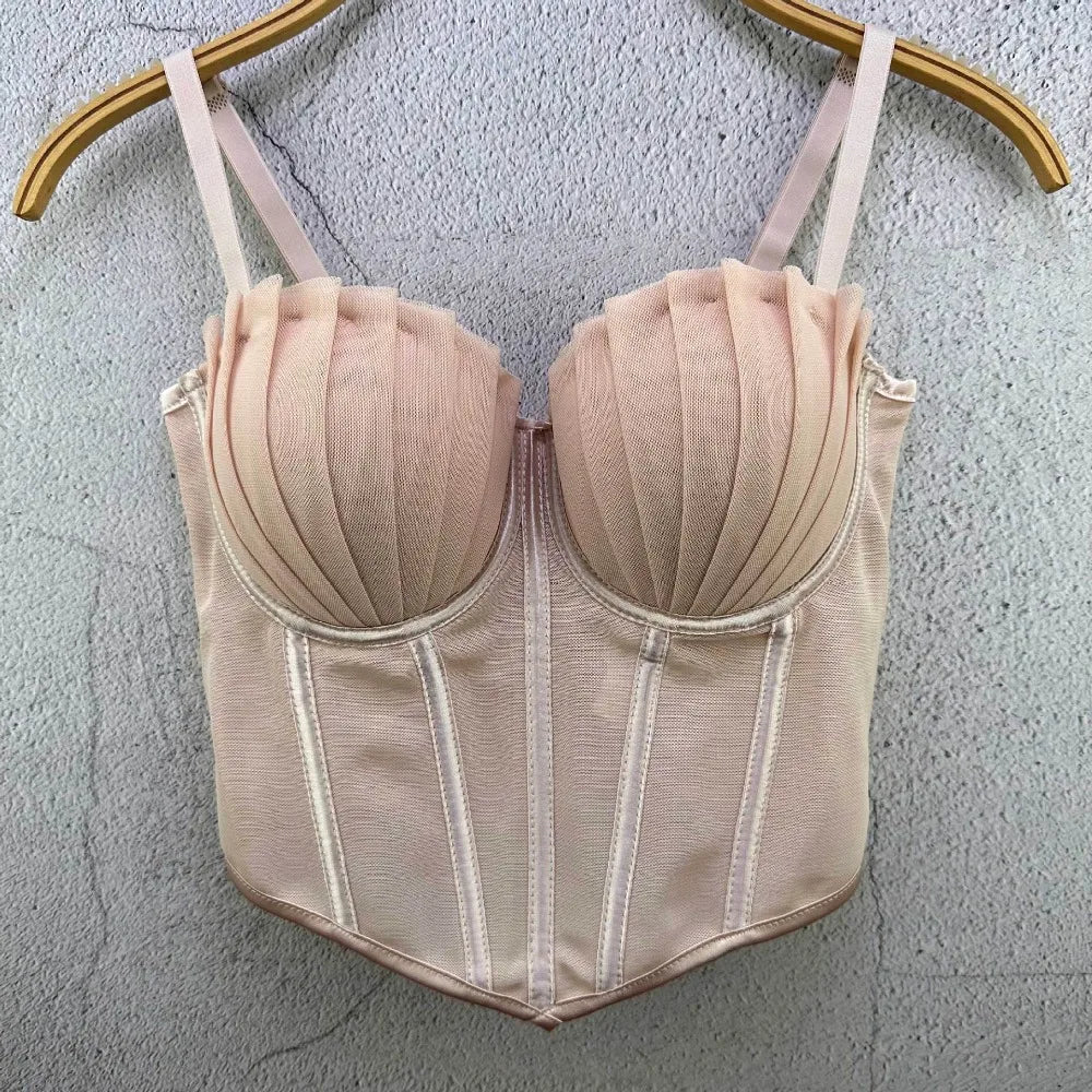 Beige sexy party club bustier top with pleated cups and adjustable straps hanging on wooden hanger