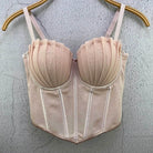Beige sexy party club bustier top with pleated cups and adjustable straps hanging on wooden hanger