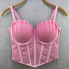 Pink sexy party club bustier top with pleated cups and adjustable straps hanging on wooden hanger