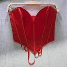 Red sexy party club bustier top with structured seams hanging on wooden hanger