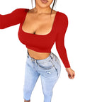 Woman wearing a red sexy summer crop top for women with long sleeves and light wash jeans