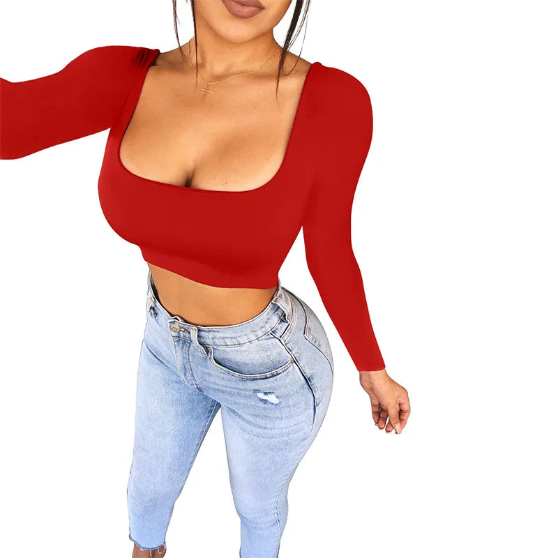 Woman wearing a red sexy summer crop top for women with long sleeves and light wash jeans