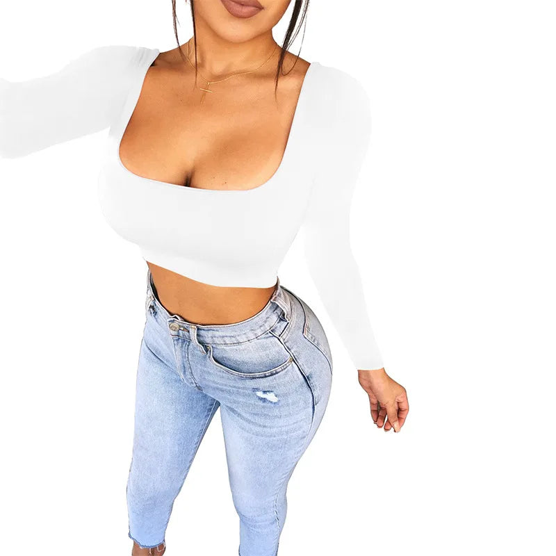 White sexy summer crop top for women paired with light blue high-waisted jeans from VacationGrabs