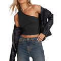 Woman wearing black one-shoulder crop top and leather jacket showcasing sexy vacation tops for women