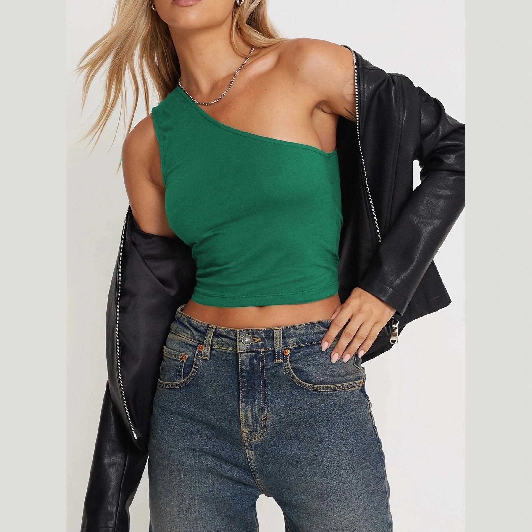 Green one shoulder crop top paired with denim jeans and black leather jacket sexy vacation tops for women