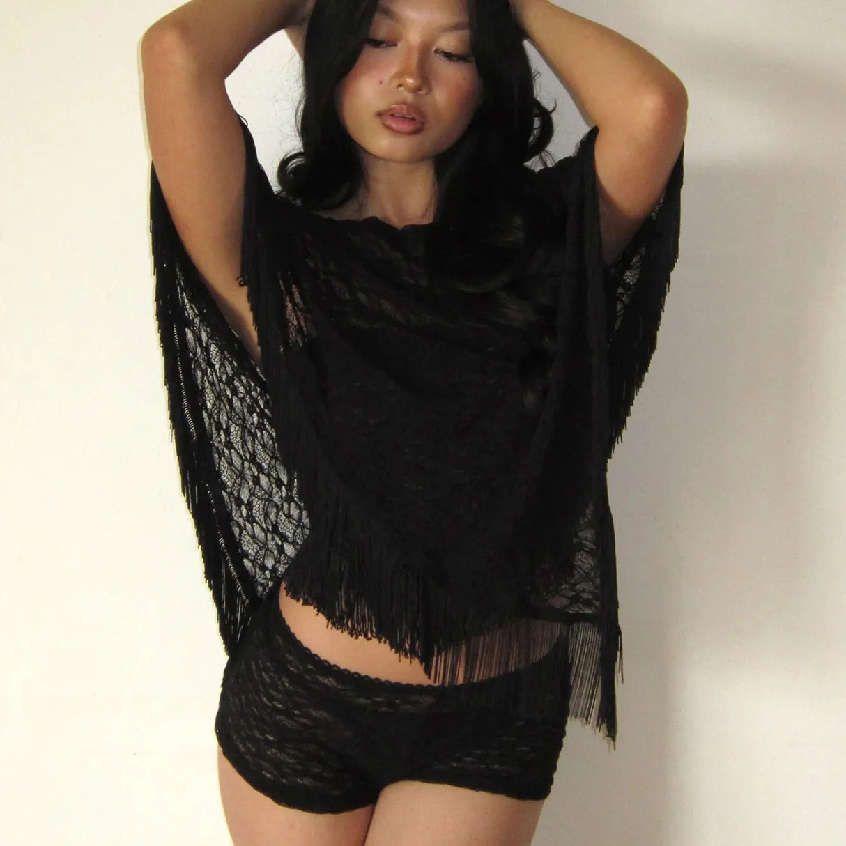 Black sheer poncho with fringe, perfect for beach cover-up