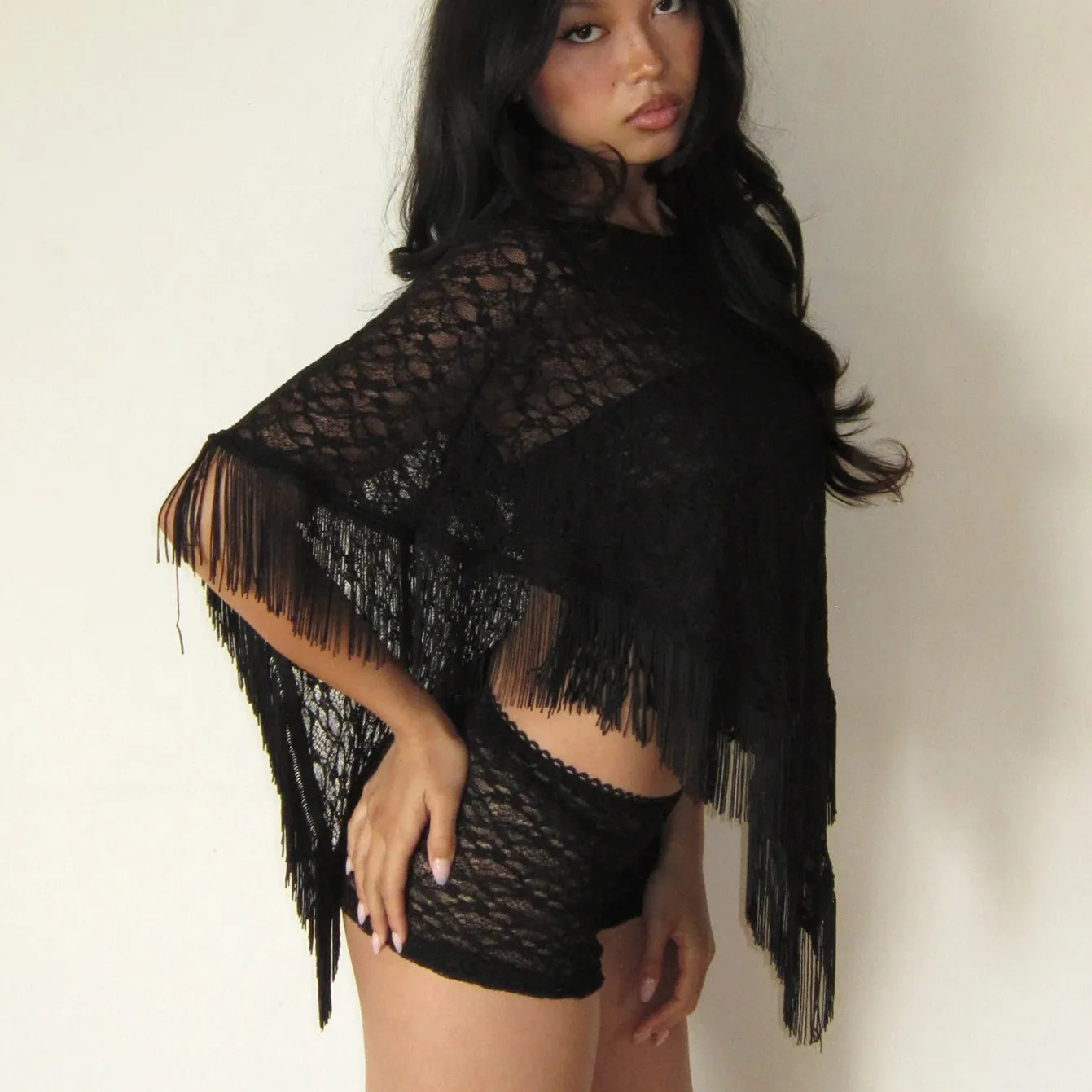 Black sheer poncho with fringe, perfect for beach cover-up