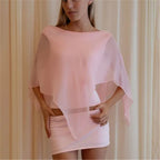 Women's sheer poncho in soft pink, perfect for beach cover-up