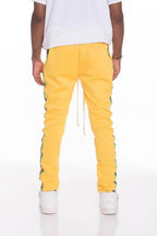 Men's yellow side taped track pants by WEIV with a trendy slim fit and stylish side design