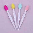 Silicone face brush for blackheads in pink, yellow, green, and blue