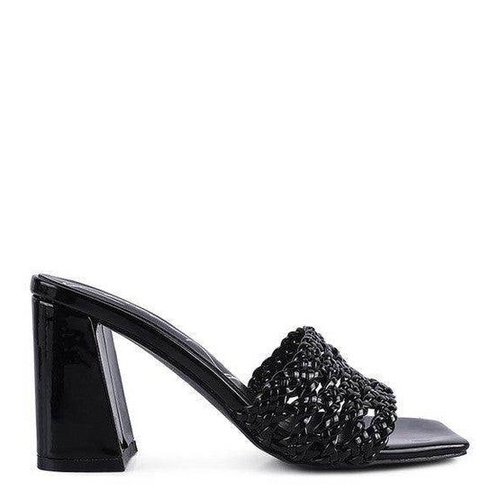 Stylish black heels with a textured design, perfect for pairing with dresses or casual outfits