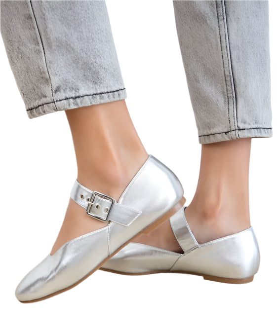Silver Mary Jane flats from Maker's Shoes worn with light gray jeans showing buckle strap detail