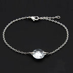Silver tone bead bracelet with a faceted central stone, perfect for casual or formal wear