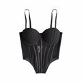 Black sexy bustier camisole for ladies with structured cups and adjustable straps on black surface