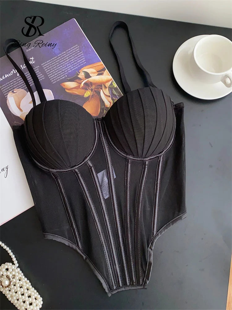 Black sexy bustier camisole for ladies with structured cups and adjustable straps on black surface