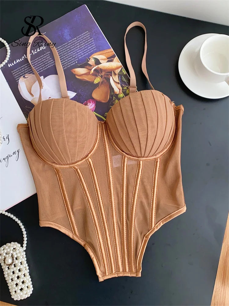 Brown sexy bustier camisole for ladies with structured cups and adjustable straps laid on black surface