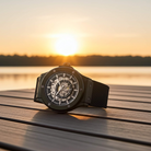 Dapr skeleton automatic watch for men on a wooden surface with sunset background