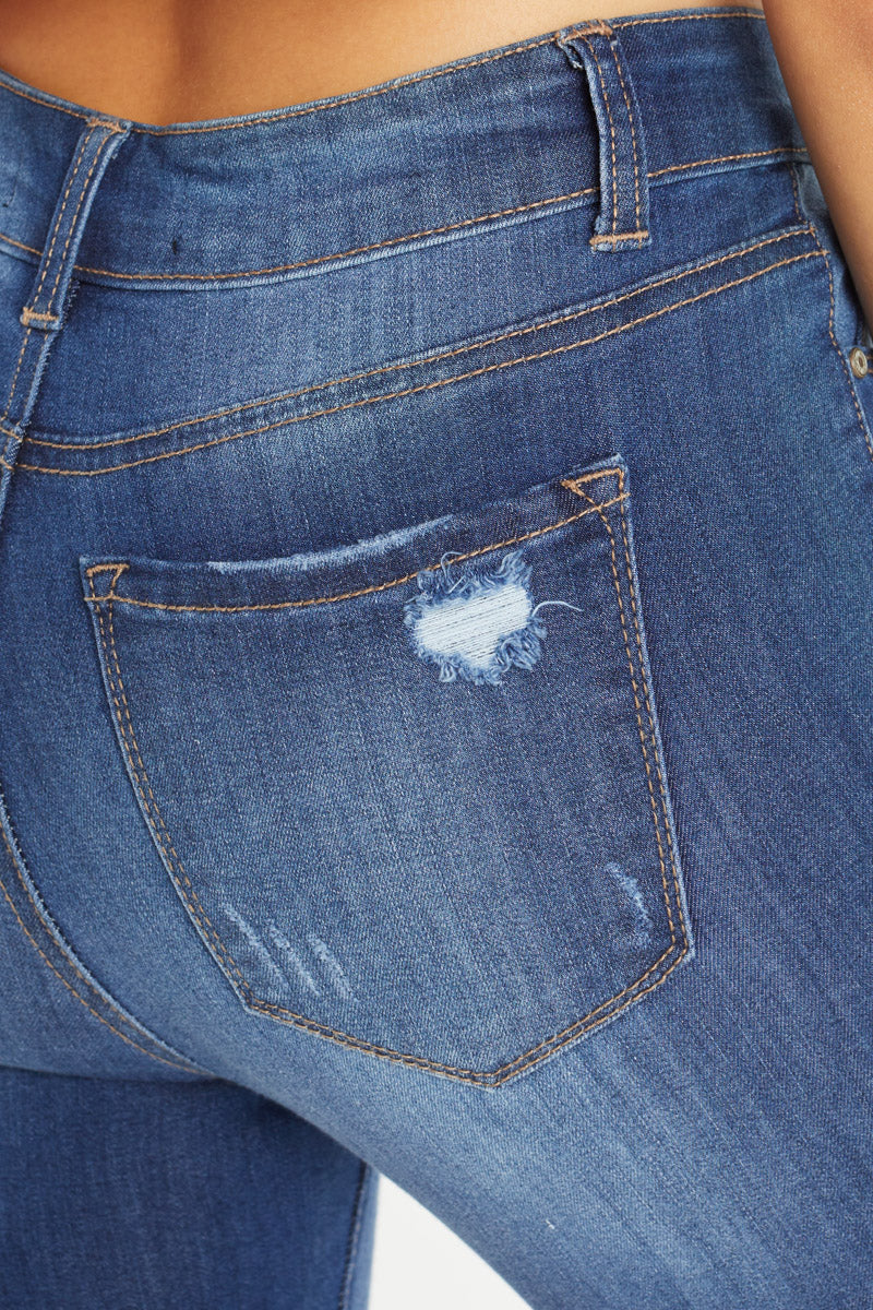 Women's blue skinny pants jeans with distressed back pocket detail