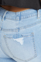 Women's light blue skinny pants jeans with distressed back pocket detail