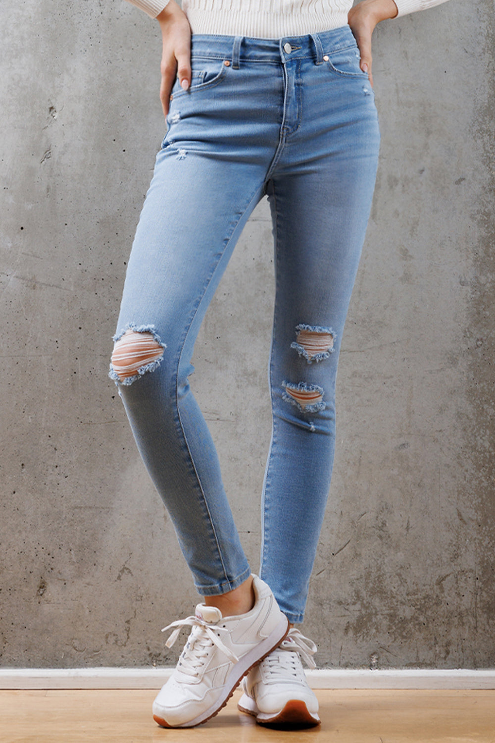 Women's light blue skinny pants jeans with distressed knee details