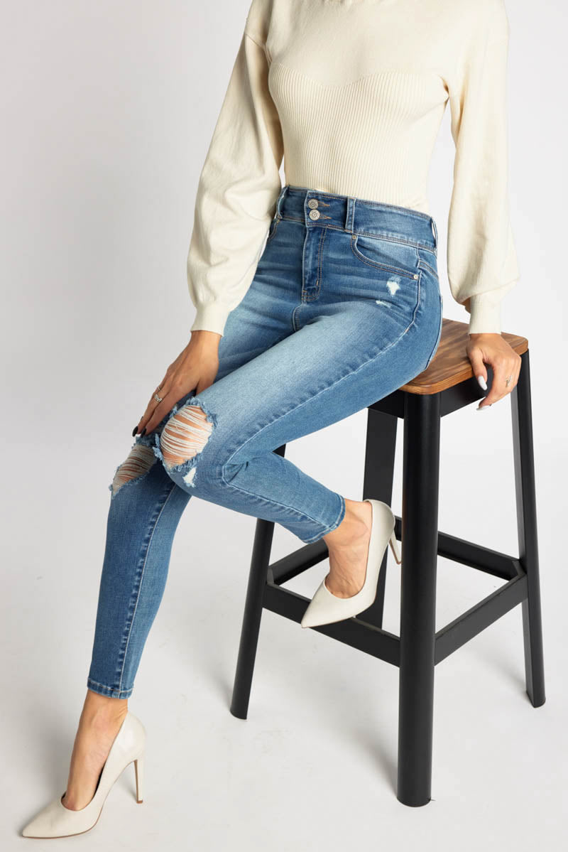 Stylish women's skinny pants jeans in light wash with distressed details
