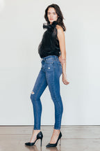Women's dark blue skinny pants jeans with a stylish top and heels
