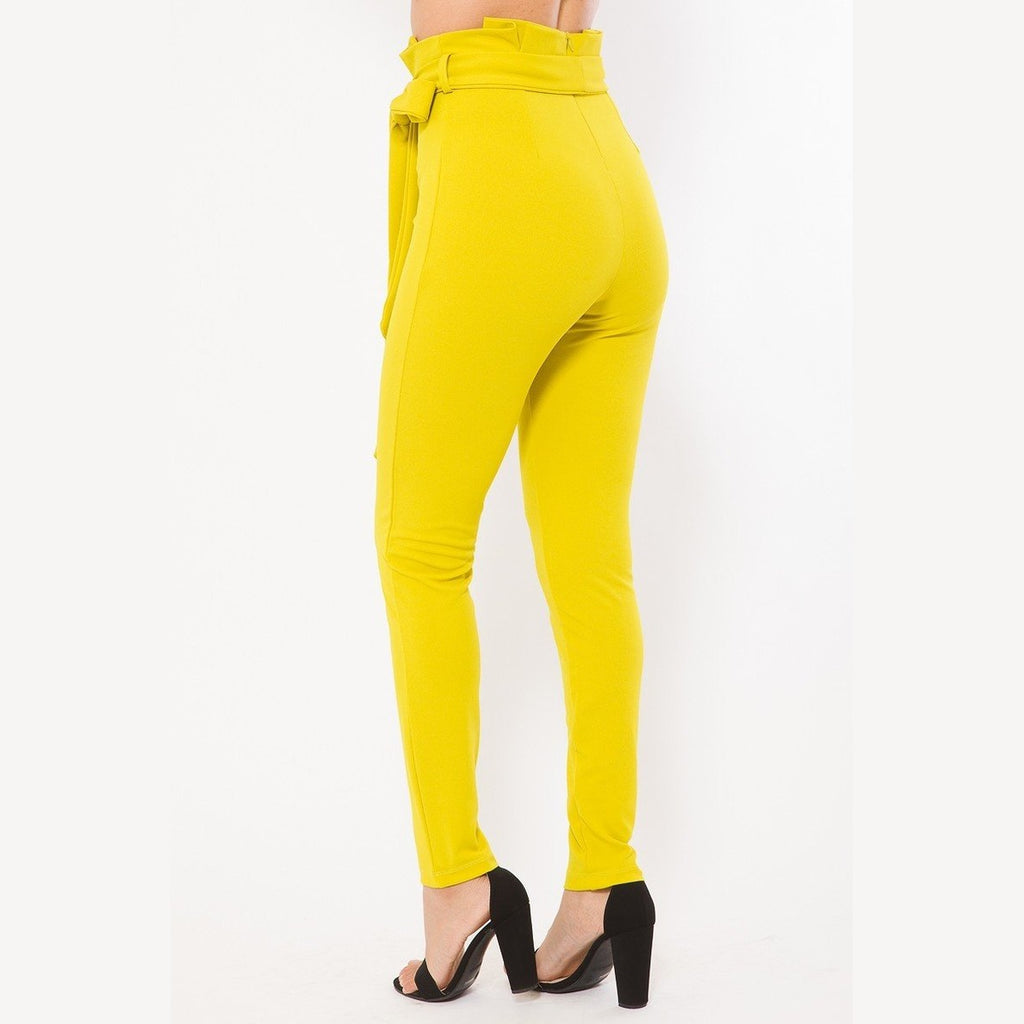 VacationGrabs women's yellow skinny pants with belt accent paired with black high heels