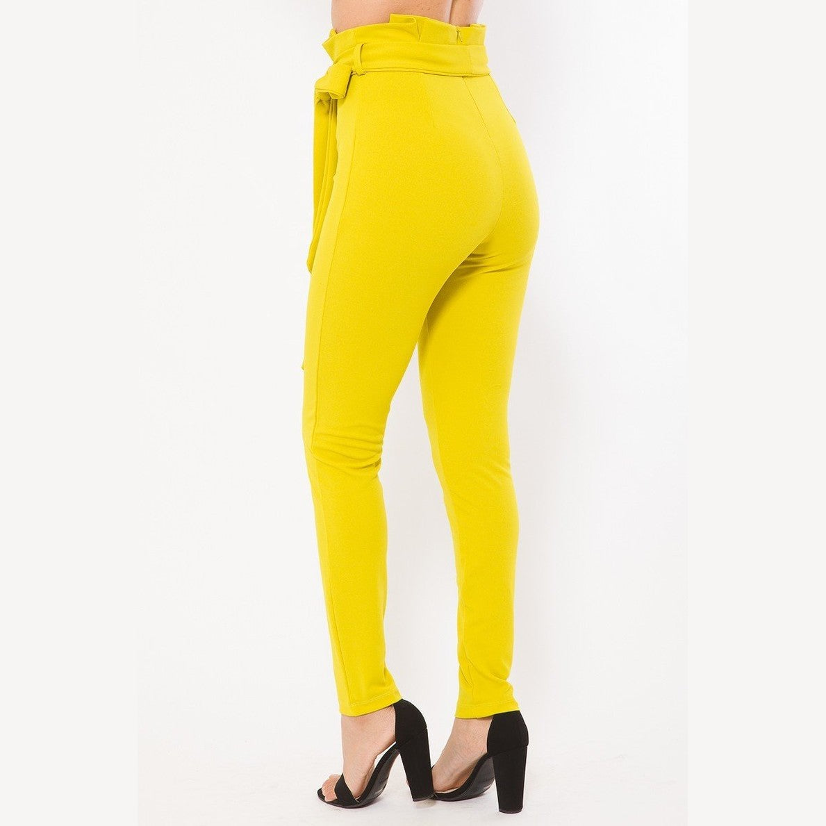 VacationGrabs women's yellow skinny pants with belt accent paired with black high heels