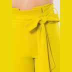 VacationGrabs women's skinny pants with belt accent in bright yellow with a tied bow detail