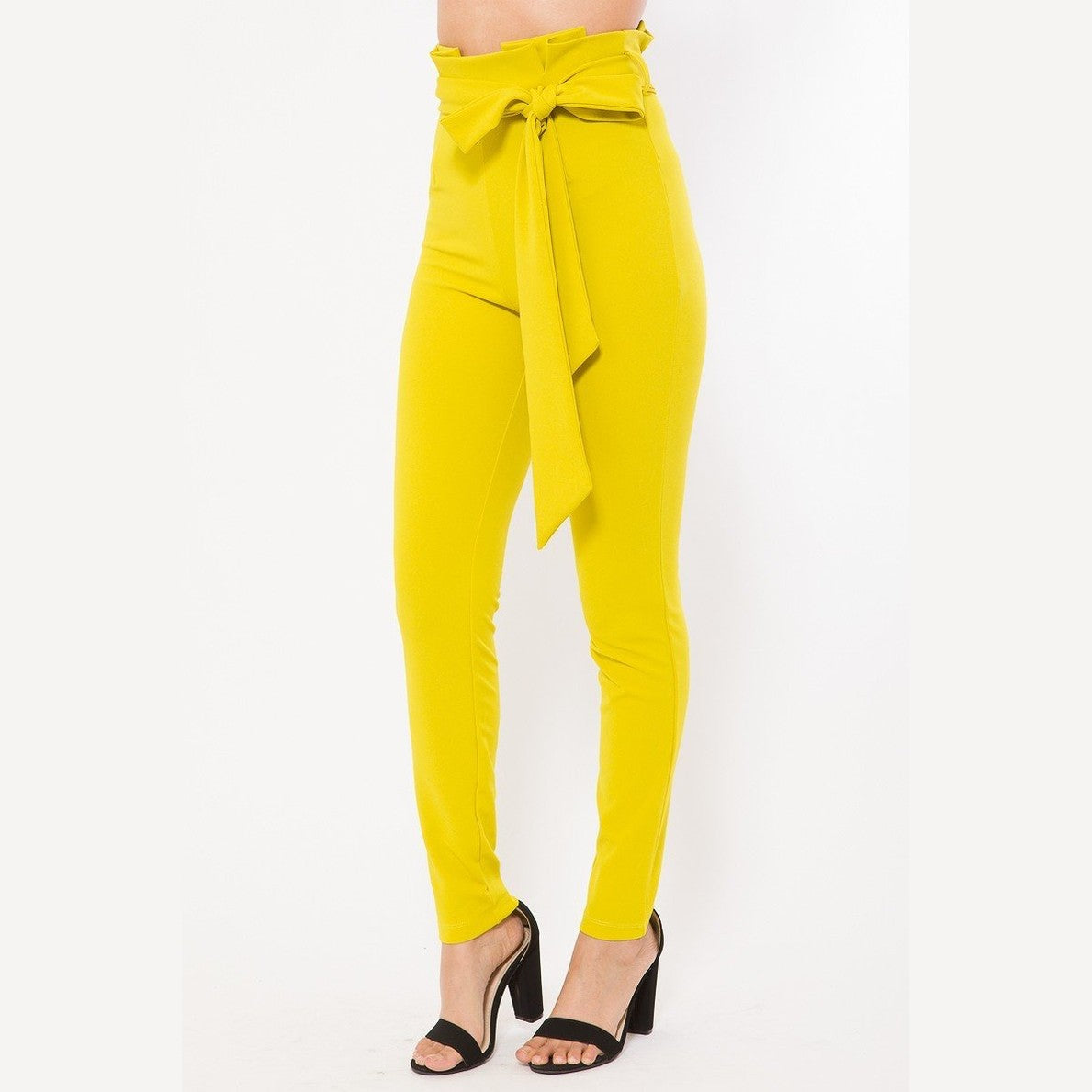 Yellow women's skinny pants with belt accent from VacationGrabs styled with black high heel sandals