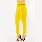 Yellow women's skinny pants with belt accent from VacationGrabs styled with black high heel sandals