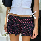 Women's black skirt pleated with pink polka dots, perfect for summer wear