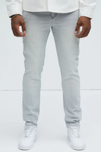 VacationGrabs slate grey jeans for men worn with white sneakers and a white shirt