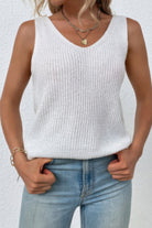 Women's sleeveless knit cross back vest in white, styled with blue jeans for a casual look